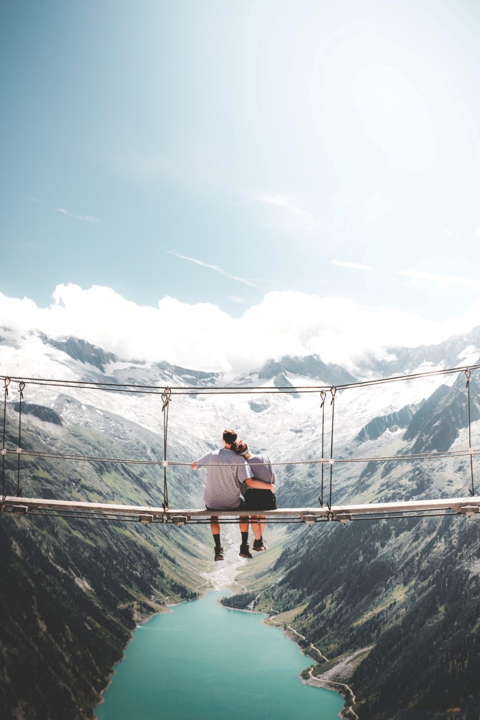 Hanging Out In The Austrian Alps. Couple on a bridge.